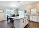Eat-in kitchen featuring a large island, stainless steel appliances and a dining area at 449 Gilson Loop, The Villages, FL 32163