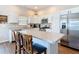 Modern kitchen with stainless steel appliances, white cabinetry, and large island with seating at 449 Gilson Loop, The Villages, FL 32163