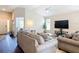 Inviting living room with neutral tones, large TV, and comfortable seating arrangement at 449 Gilson Loop, The Villages, FL 32163