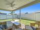Covered screened-in lanai with ceiling fan and comfortable seating overlooking the yard at 449 Gilson Loop, The Villages, FL 32163