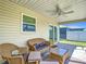 Relaxing screened patio with comfortable seating, ceiling fan and backyard views at 449 Gilson Loop, The Villages, FL 32163