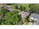 Aerial view of home with a pool, lush landscaping, fenced yard and mature trees in a tranquil neighborhood at 5138 Rishley Run Way, Mount Dora, FL 32757
