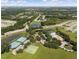 An aerial view displays community amenities like a pool, tennis courts, basketball court, and ponds, nestled among trees and homes at 5138 Rishley Run Way, Mount Dora, FL 32757