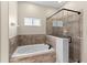 Cozy bathroom with a tub and tiled shower, creating a tranquil space at 5138 Rishley Run Way, Mount Dora, FL 32757