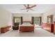 Well-lit bedroom with a ceiling fan, and dual windows providing ample natural light at 5138 Rishley Run Way, Mount Dora, FL 32757