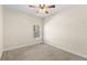 Cozy bedroom featuring neutral colors, a window, and a ceiling fan at 5138 Rishley Run Way, Mount Dora, FL 32757