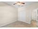 Bedroom with a closet, neutral walls, carpet, and ceiling fan at 5138 Rishley Run Way, Mount Dora, FL 32757
