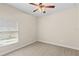 Neutral bedroom features a ceiling fan and a bright window at 5138 Rishley Run Way, Mount Dora, FL 32757