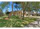 Inviting two-story home featuring a well-manicured lawn and mature landscaping at 5138 Rishley Run Way, Mount Dora, FL 32757