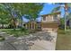 Charming two-story home with a well-manicured lawn, lush landscaping, and a welcoming front porch at 5138 Rishley Run Way, Mount Dora, FL 32757