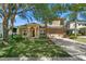 Charming home exterior with a well-manicured lawn, mature trees, and a two-car garage at 5138 Rishley Run Way, Mount Dora, FL 32757