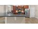 A modern kitchen features stainless steel appliances and ample counter space at 5138 Rishley Run Way, Mount Dora, FL 32757