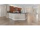 Open kitchen featuring dark cabinetry, stainless appliances, and breakfast bar seating at 5138 Rishley Run Way, Mount Dora, FL 32757