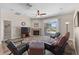 Living room showcases a fireplace, ceiling fan, and access to the outdoor pool area at 5138 Rishley Run Way, Mount Dora, FL 32757