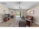 Bright living room features a fireplace, ceiling fan, and sliding glass door access to the pool at 5138 Rishley Run Way, Mount Dora, FL 32757