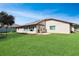 Spacious backyard with lush grass, patio and mature landscaping at 5408 Queen Victoria Dr, Leesburg, FL 34748