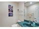 Half bathroom featuring fish art, toilet, teal sink, and shelves at 5408 Queen Victoria Dr, Leesburg, FL 34748