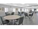 Spacious dining area featuring round tables and chairs at 5408 Queen Victoria Dr, Leesburg, FL 34748