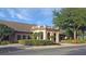Exterior view of community center featuring architectural details and landscaping at 5408 Queen Victoria Dr, Leesburg, FL 34748