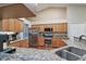 Modern kitchen boasting stainless steel appliances, granite counters and hardwood floors at 5408 Queen Victoria Dr, Leesburg, FL 34748