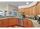 Bright kitchen with granite countertops, stainless steel appliances, and wood cabinets at 5408 Queen Victoria Dr, Leesburg, FL 34748