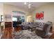 Spacious living room features vaulted ceilings, comfortable seating, and ample natural light at 5408 Queen Victoria Dr, Leesburg, FL 34748