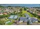 An overhead view of neighborhood amenities, including the pool, tennis courts, clubhouse, and common area at 5557 Freeport Dr, Tavares, FL 32778