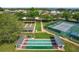 Overhead shot of community amenities featuring bocce ball and shuffleboard courts, plus a tennis court at 5557 Freeport Dr, Tavares, FL 32778