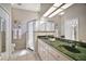 Bright bathroom features a glass shower, tile floors, and a vanity with ample counter space at 5557 Freeport Dr, Tavares, FL 32778