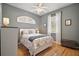Inviting bedroom with natural light, hardwood floors, and neutral color palette at 5557 Freeport Dr, Tavares, FL 32778