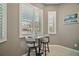 Charming breakfast nook with granite table top, seating for two, and window views at 5557 Freeport Dr, Tavares, FL 32778