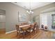 Inviting dining room with hardwood floors, chandelier, and natural light at 5557 Freeport Dr, Tavares, FL 32778