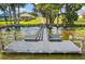 Beautiful dock with benches, providing a perfect spot to relax and enjoy the serene waterfront at 5557 Freeport Dr, Tavares, FL 32778