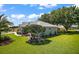 Charming single-story home with a well-manicured lawn and beautiful landscaping, creating a welcoming curb appeal at 5557 Freeport Dr, Tavares, FL 32778