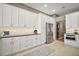 Bright kitchen features white cabinets, granite countertops, stainless steel appliances, and tiled backsplash at 5557 Freeport Dr, Tavares, FL 32778