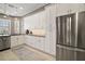 Well-lit kitchen featuring stainless steel appliances, granite counters, white cabinets, and a breakfast nook at 5557 Freeport Dr, Tavares, FL 32778