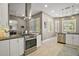 Spacious kitchen boasts stainless steel appliances, granite countertops, white cabinets, and natural light from plantation shutters at 5557 Freeport Dr, Tavares, FL 32778