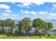 Scenic lake view showcasing mature trees along the shoreline, creating a tranquil and natural backdrop at 5557 Freeport Dr, Tavares, FL 32778