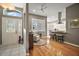 Open-concept living area with hardwood floors, leading into the kitchen, and a glass front door creating a seamless flow at 5557 Freeport Dr, Tavares, FL 32778