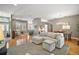 Bright living space featuring hardwood floors, an open layout with a dining area, and a glimpse of the entryway at 5557 Freeport Dr, Tavares, FL 32778