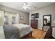 Comfortable main bedroom with hardwood floors, ceiling fan, and private patio access at 5557 Freeport Dr, Tavares, FL 32778