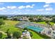 Aerial shot showcasing the enclosed community pool, surrounded by ample seating and lush green space at 5557 Freeport Dr, Tavares, FL 32778