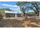 A spacious backyard with a patio seating area, ideal for outdoor activities and relaxation at 602 Ross St, Leesburg, FL 34748