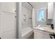 Bathroom features marble tiled shower and modern vanity at 602 Ross St, Leesburg, FL 34748