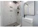 A stylish bathroom with a modern shower, tiled walls, black fixtures, and a sleek, white sink at 602 Ross St, Leesburg, FL 34748