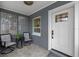 Cozy covered front porch with seating area, perfect for relaxing outdoors at 602 Ross St, Leesburg, FL 34748