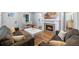 Elegant living room with fireplace, mantle, and comfortable seating arrangement at 602 Ross St, Leesburg, FL 34748