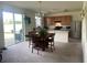 Open-concept kitchen with wood cabinets, stainless steel appliances, and a dining area at 709 Sarner Pass Way, Winter Haven, FL 33881
