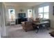 Comfortable living room featuring neutral carpeting and plenty of natural light at 709 Sarner Pass Way, Winter Haven, FL 33881