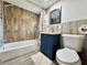 Bathroom featuring blue vanity with drawers, tub with showerhead, and decorative shower curtain at 726 S Stone St, Deland, FL 32720
